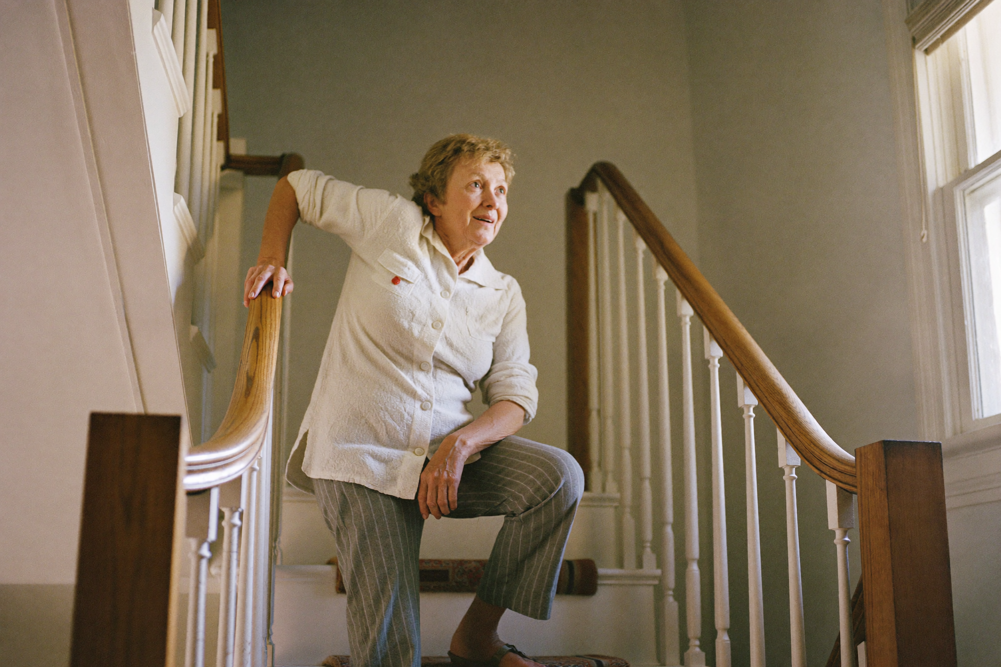 Woman pausing at the bottom of the stairs in the morning